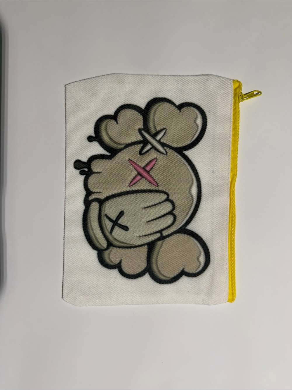 KAWS White Canvas Pouch with Beige Character and Yellow Zipper